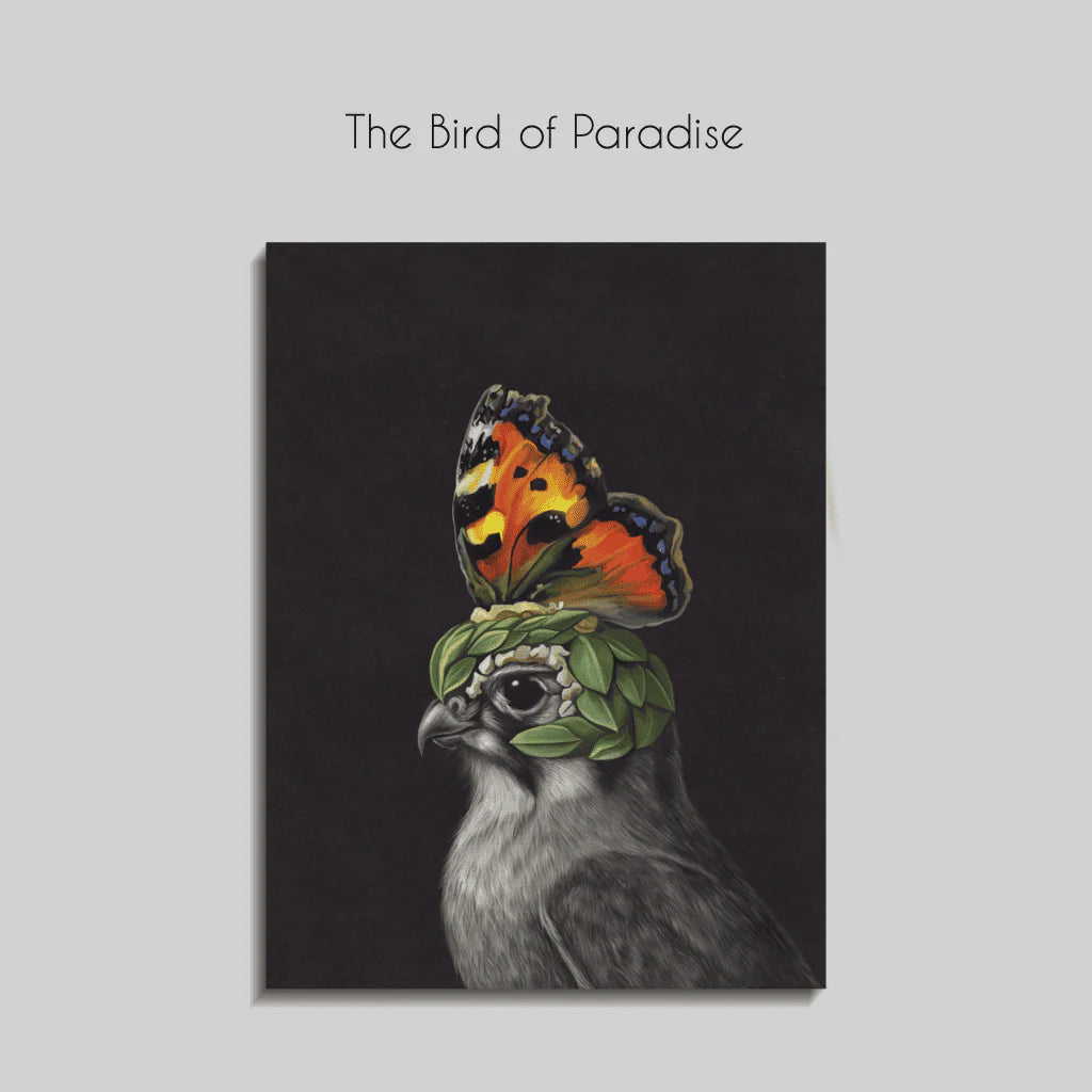 A striking canvas artwork featuring a regal hawk with a surreal twist — its head adorned with green leaves and a vivid orange butterfly perched like a crown. Set against a deep black background, the image blends realism with fantasy, highlighting transformation and duality. Displayed in a sleek, modern room with dark tones and minimalist furniture, the piece adds a bold, imaginative focal point.
